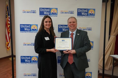 A campaign coordinator accepts a certificate of appreciation