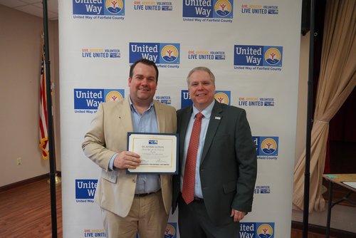 The city law director accepts a certificate of appreciation