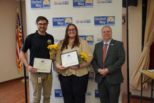 Two campaign coordinators accept certificates and flowers