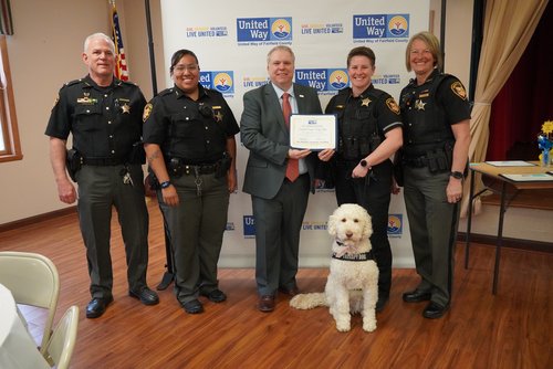 Fairfield County Sheriff's Office deputies and their comfort dog accept a campaign award