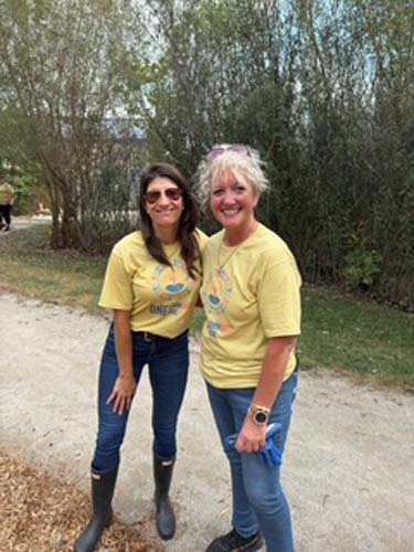 Two volunteers posing on a freshly mulched walking path