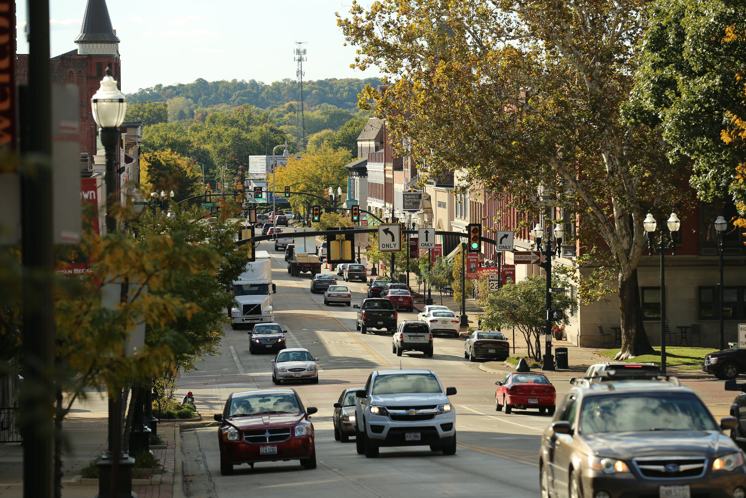 Traffic and storefronts along Main Street in downtown Lancaster on an autumn afternoon