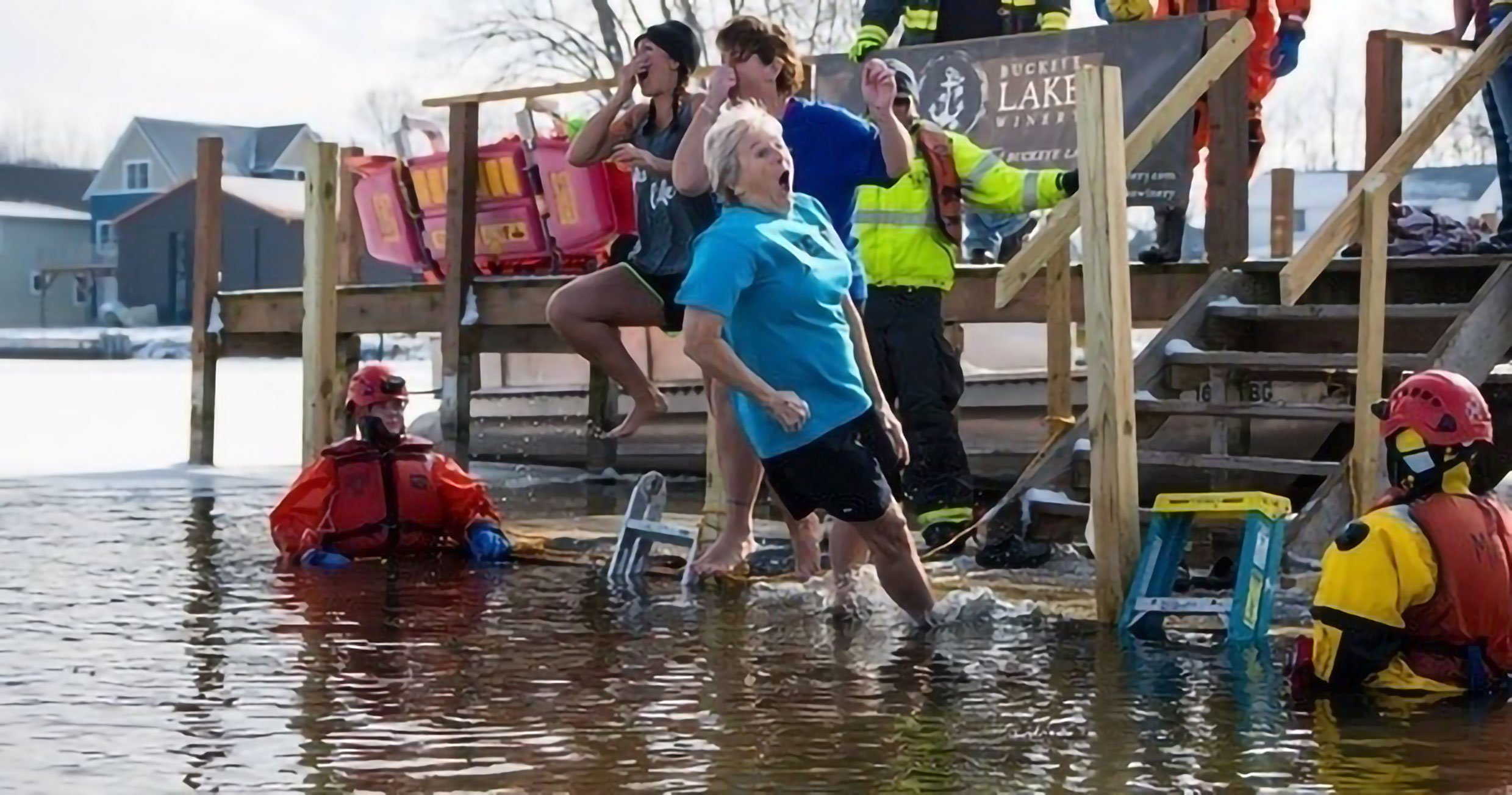 Plungers leaping into the icy water at Buckeye Lake Winery while rescue crews stand by